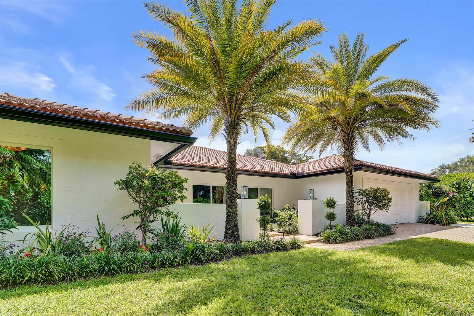 A single-story white house with a tile roof and two tall palm trees in front — 2804 Banyan Boulevard Circle NW, Boca Raton FL 33431, BOCA RATON, FL