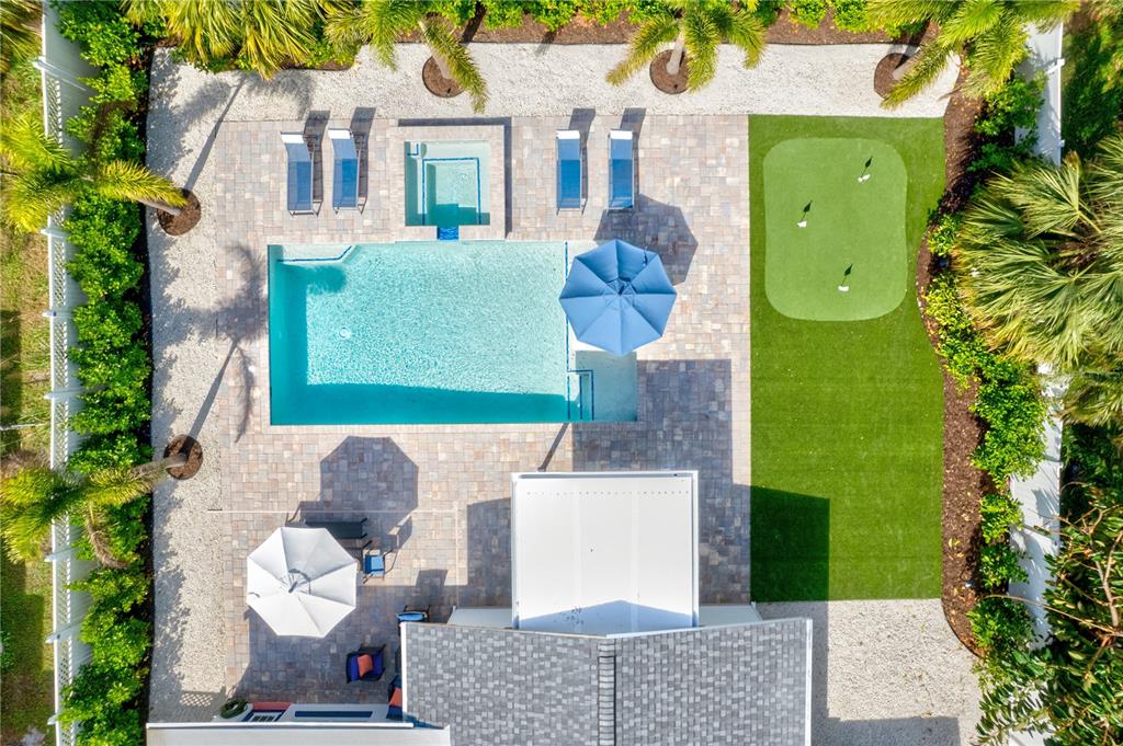 An aerial view of a backyard featuring a swimming pool, spa, putting green, and patio — 2365 BAY STREET, SARASOTA, FL