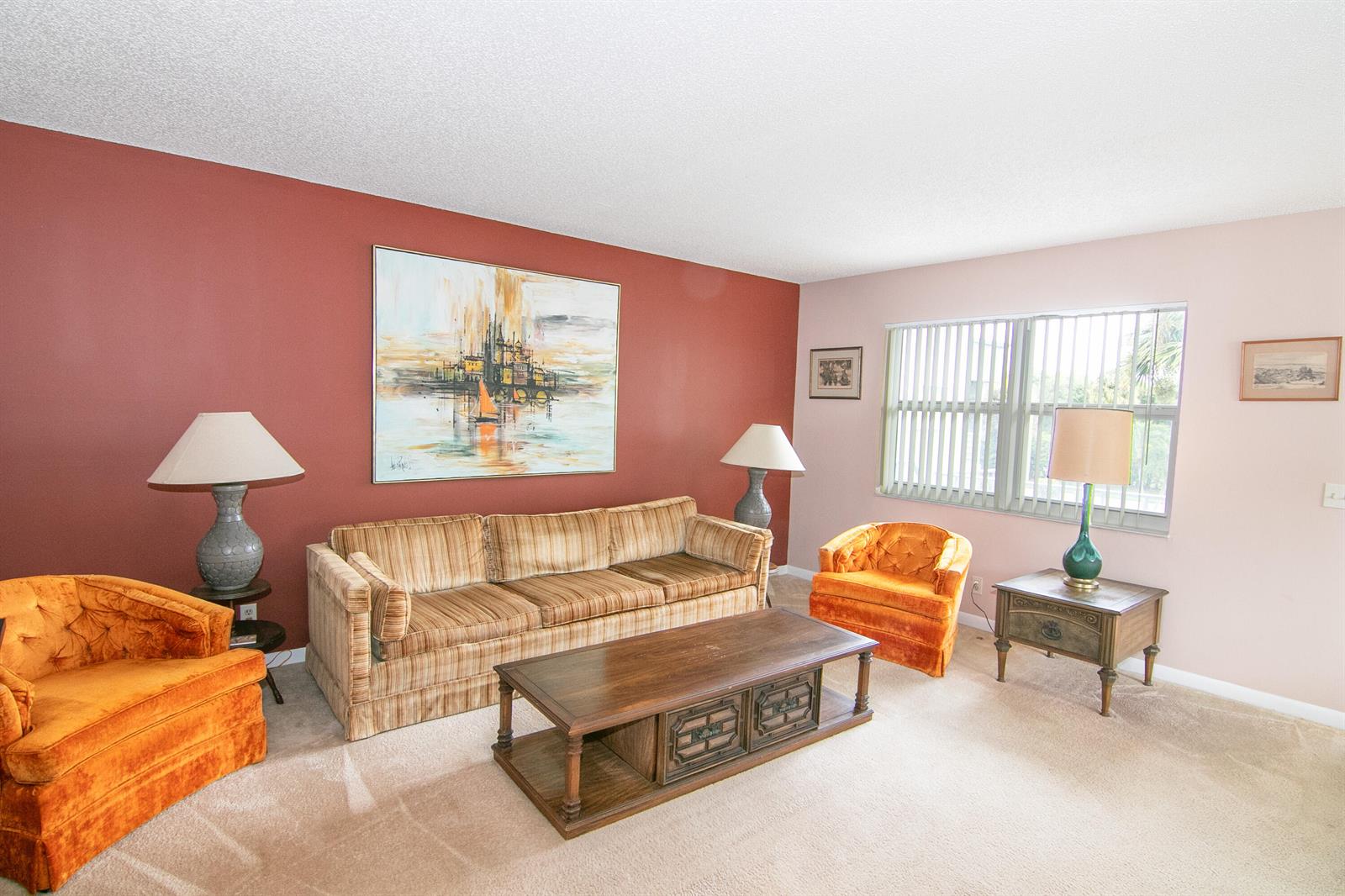 A living room features a striped sofa, two orange armchairs, and a wooden coffee table — 39 Burgundy A, Delray Beach FL 33484, DELRAY BEACH, FL