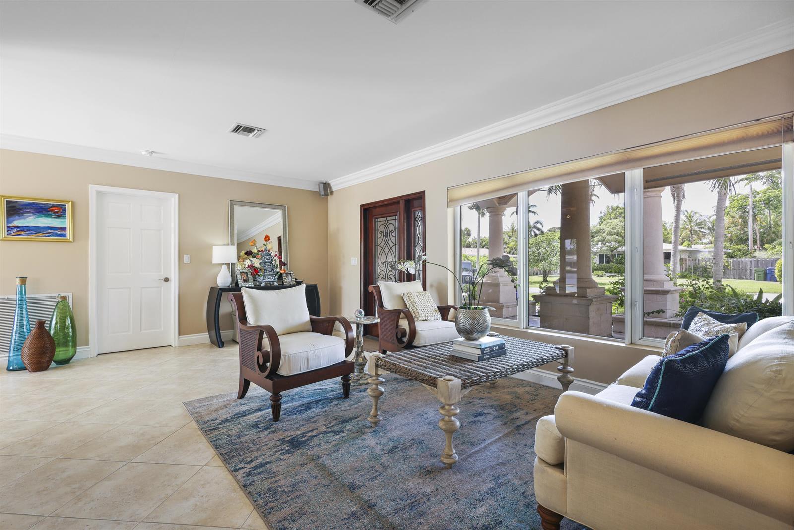 A living room features tile floors, a patterned rug, two armchairs, and a sofa — 1925 Coral Gardens Drive, Wilton Manors FL 33306, WILTON MANORS, FL