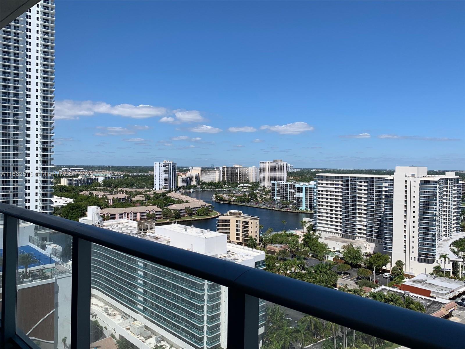 A high-angle view from a balcony overlooks a waterway surrounded by residential apartment buildings — 4111 S Ocean Dr # 1512, Hollywood FL 33019, HOLLYWOOD, FL
