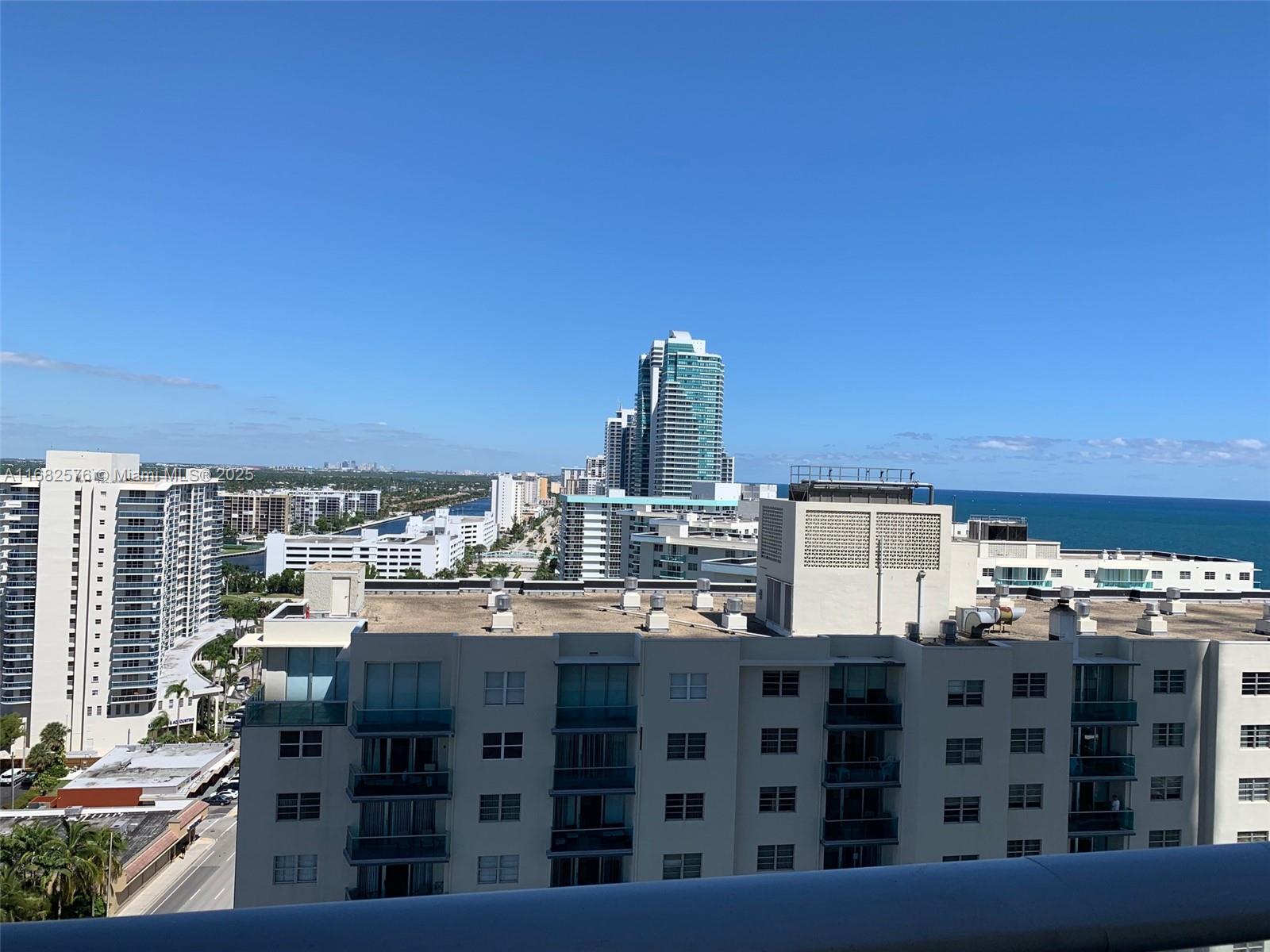 An elevated exterior view of several high-rise apartment buildings near the ocean under clear skies — 4111 S Ocean Dr # 1512, Hollywood FL 33019, HOLLYWOOD, FL