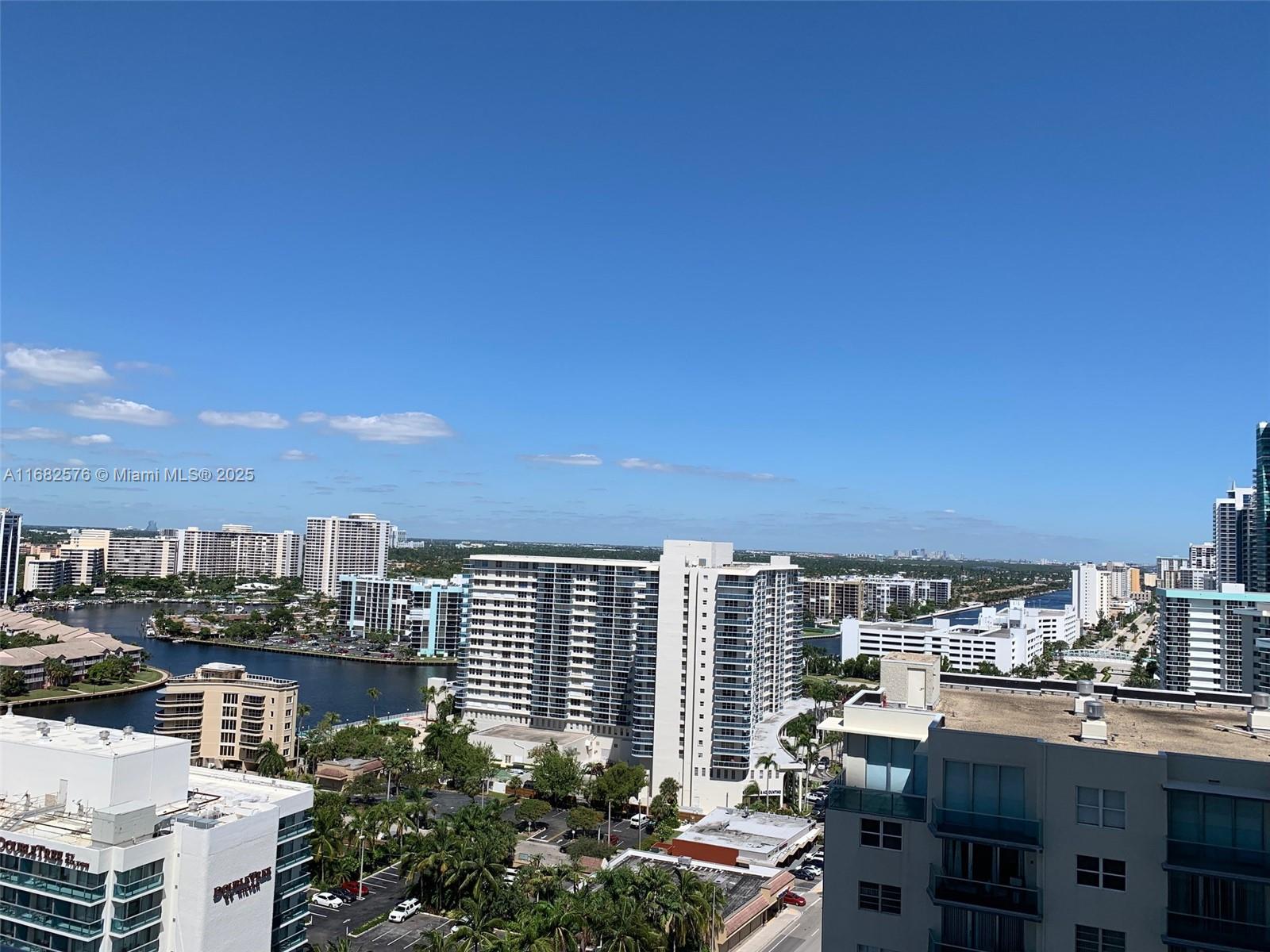 An elevated view of a coastal city featuring high-rise buildings, a waterway, and palm trees — 4111 S Ocean Dr # 1512, Hollywood FL 33019, HOLLYWOOD, FL