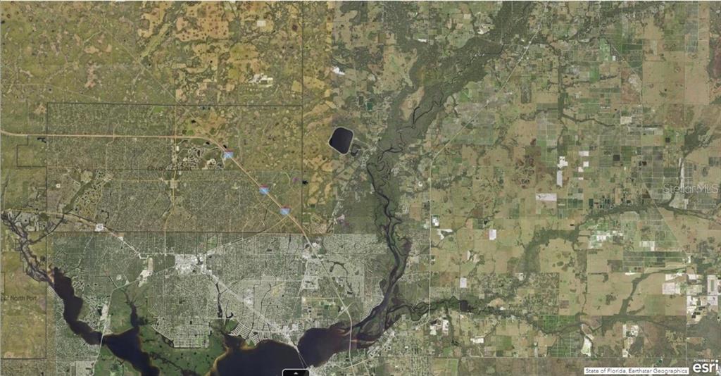 This is an aerial map view showing a river, surrounding land, and residential development — 1127226126 LARGELEAF STREET, NORTH PORT, FL