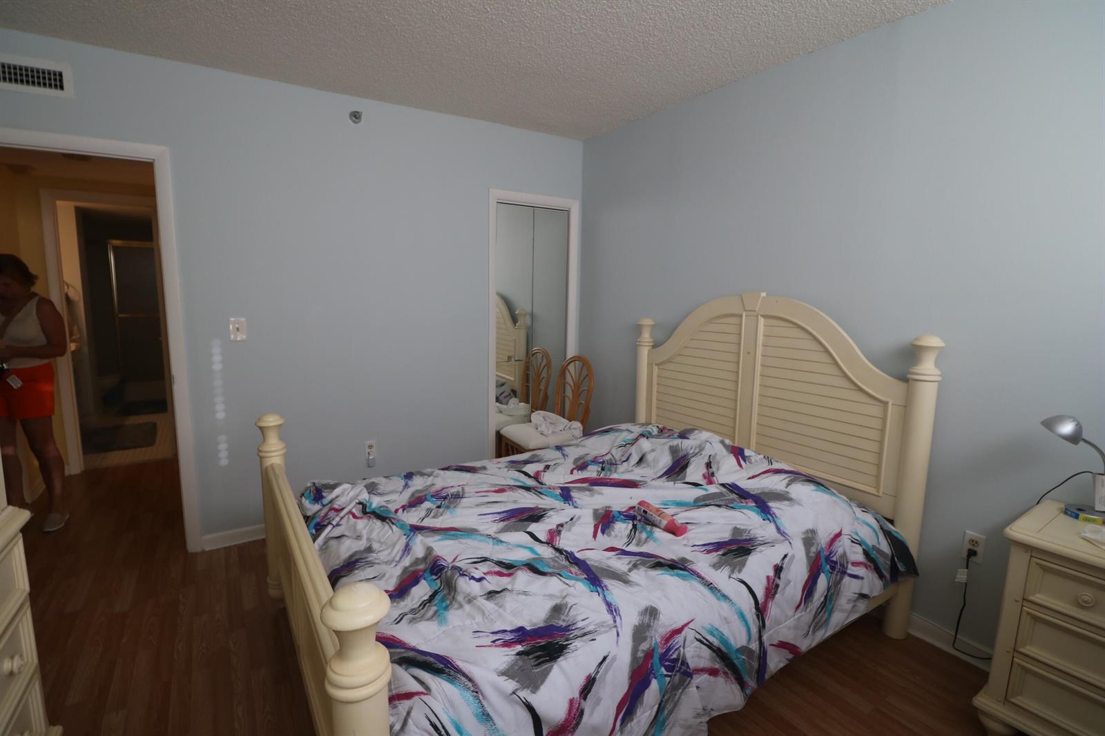 A bedroom features a light-colored wooden bed frame, patterned bedding, and light blue walls — 4001 Hillcrest Drive # 510, Hollywood FL 33021, HOLLYWOOD, FL