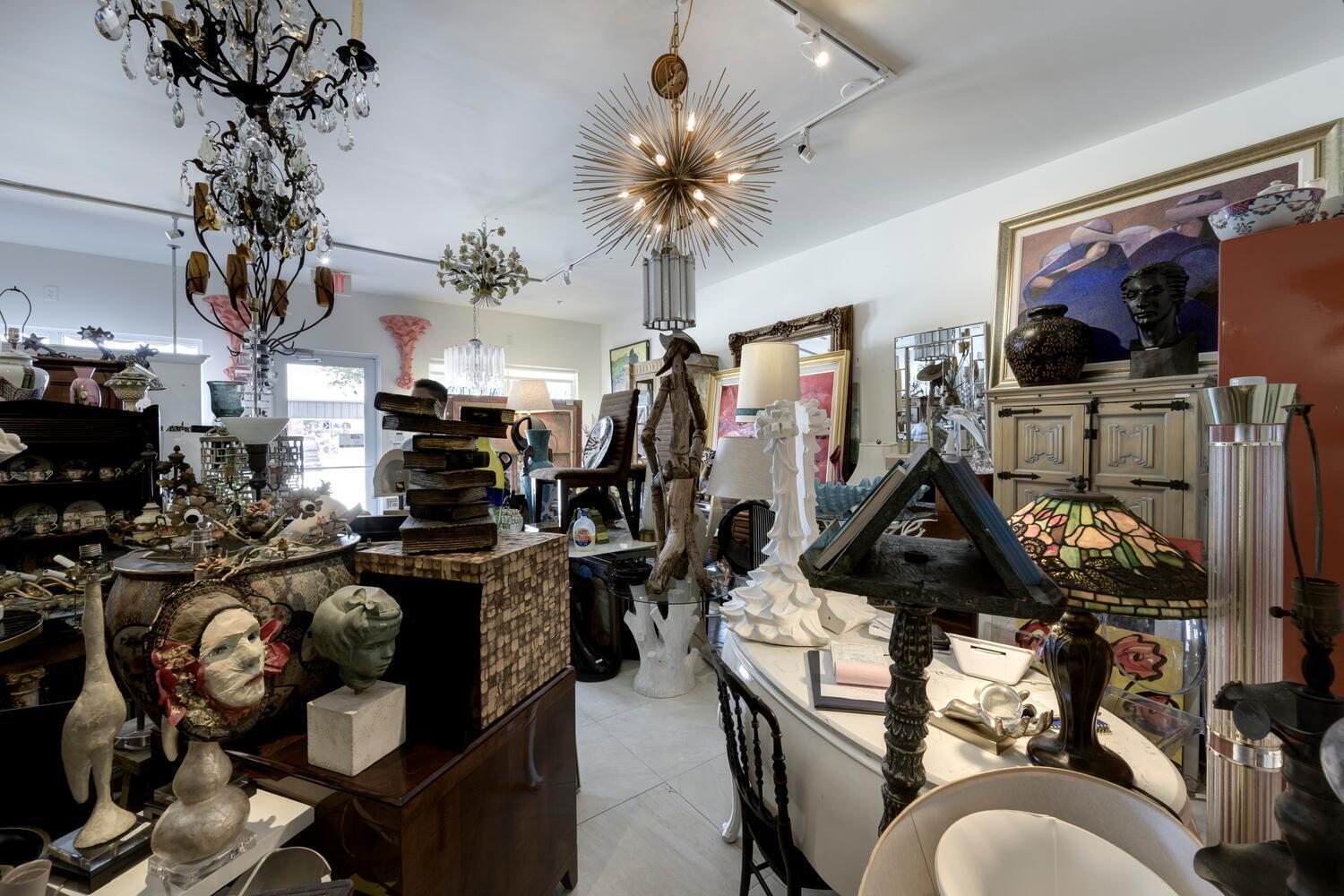 An interior view of a cluttered antique shop filled with various lamps, sculptures, and furniture — 3602 S Dixie Highway # 110, West Palm Beach FL 33405, WEST PALM BEACH, FL