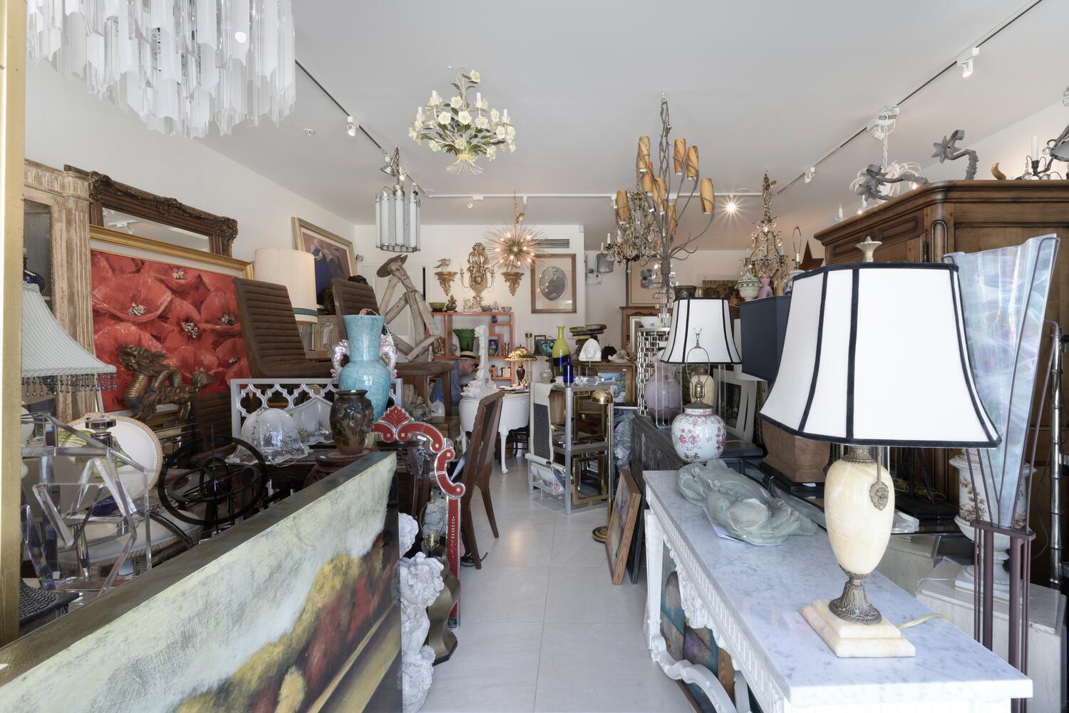 A cluttered antique store interior filled with various lamps, chandeliers, furniture, and decorative art pieces — 3602 S Dixie Highway # 110, West Palm Beach FL 33405, WEST PALM BEACH, FL