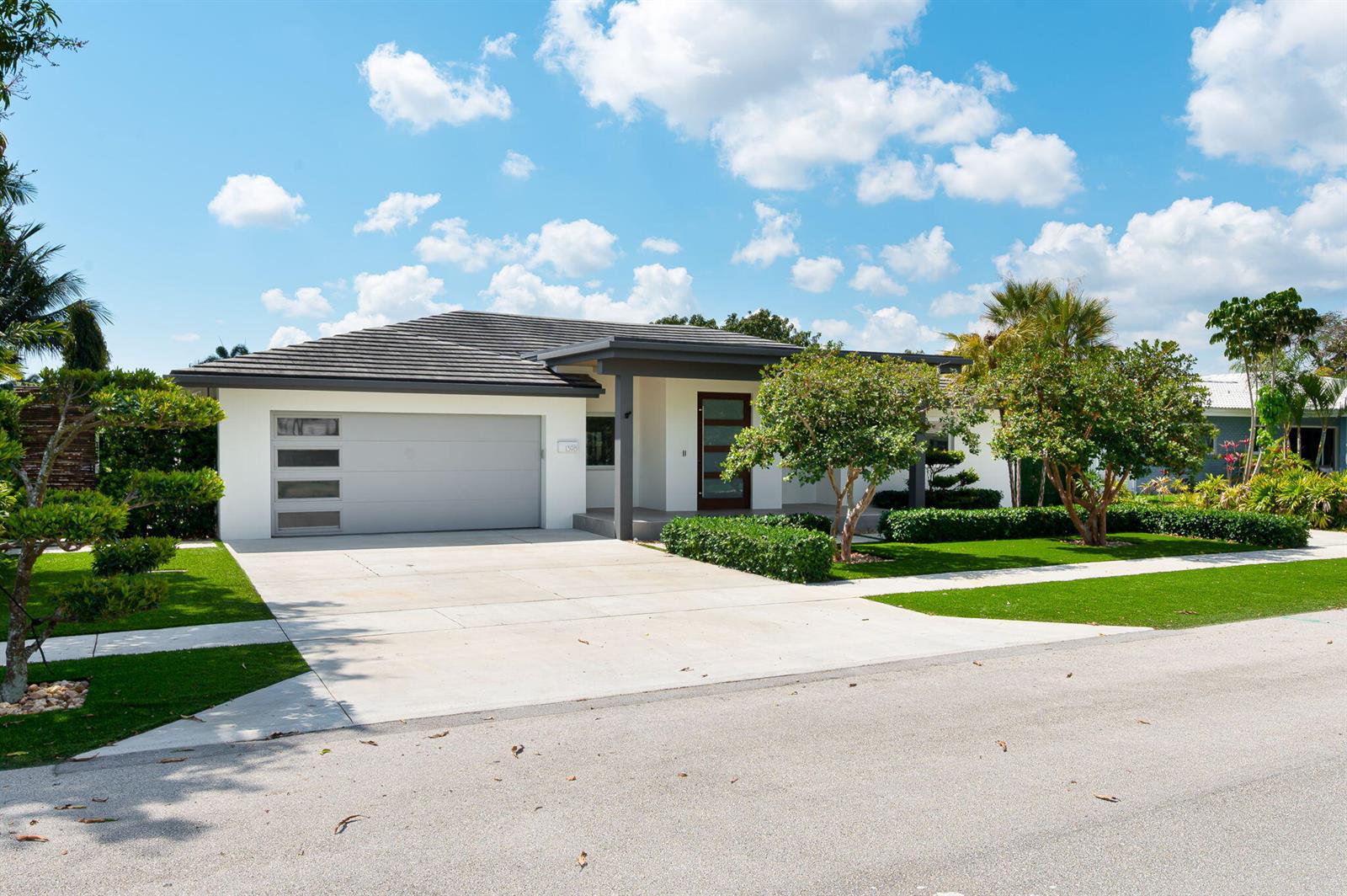 A modern single-story house with a gray garage door, white exterior, and a manicured lawn — 1398 SW 14th Street, Boca Raton FL 33486, BOCA RATON, FL