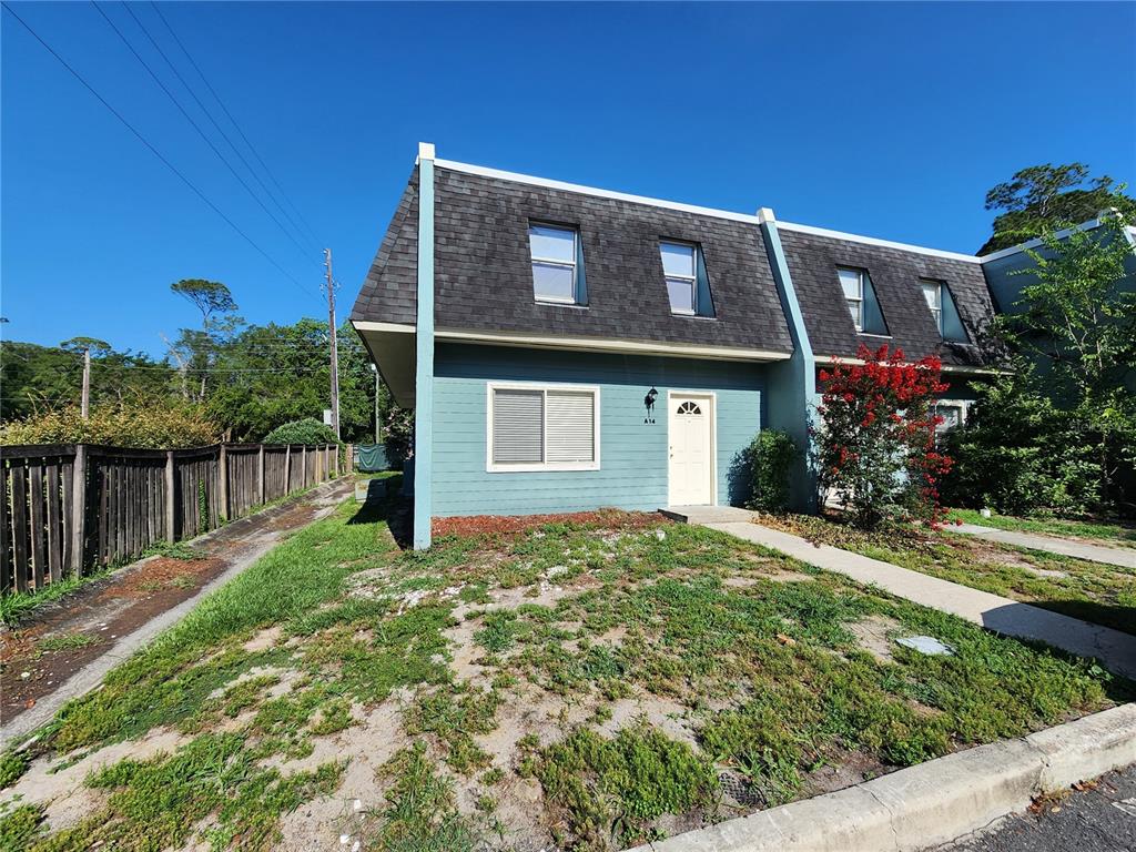 A blue two-story townhouse with a mansard roof and a small front yard — 501 SW 75 STREET UNIT A14, GAINESVILLE, FL