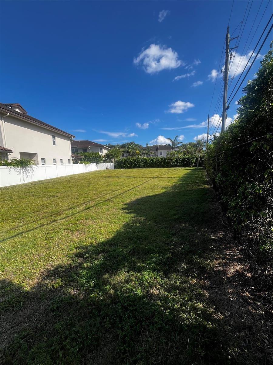 A vacant, grassy residential lot bordered by a white fence and a hedge — 1855 Copley Place, Delray Beach FL 33445, DELRAY BEACH, FL