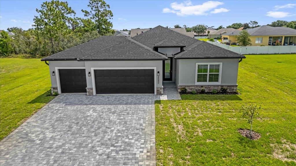 A single-story house with a gray exterior, dark roof, and a paved driveway — 5300 PONCE DE LEON BOULEVARD, SEBRING, FL