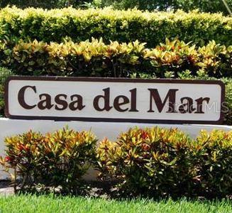 A sign reading Casa del Mar sits in front of a hedge and green lawn — 6211 SUN BOULEVARD UNIT 215, ST PETERSBURG, FL