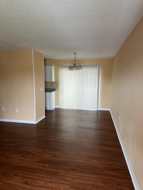 A dining area with wood-look flooring, a chandelier, and a sliding glass door — 5133 OLD HIGHWAY 37, LAKELAND, FL