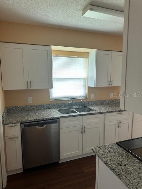 A kitchen features white cabinets, granite countertops, a stainless steel dishwasher, and a window — 5133 OLD HIGHWAY 37, LAKELAND, FL