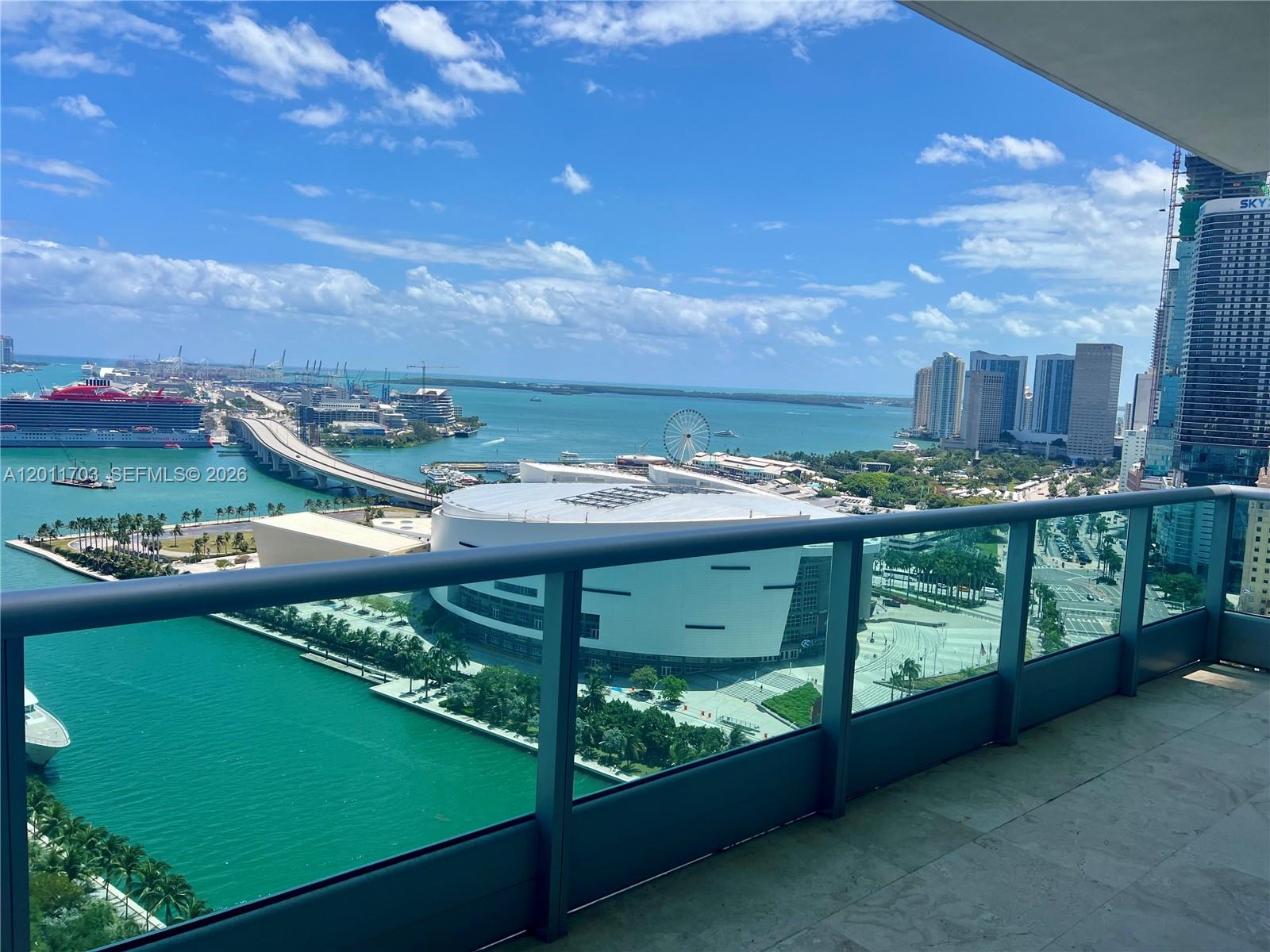 A high-rise balcony overlooks the Kaseya Center, a cruise ship, and the Miami skyline — 900 Biscayne Blvd # 2904, Miami FL 33132, MIAMI, FL