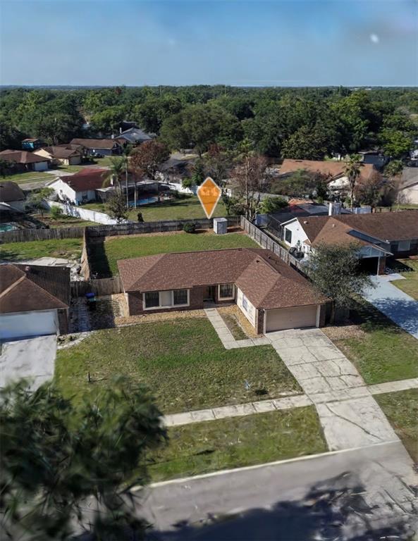 An aerial view shows a single-story house with a brown roof and a concrete driveway — 9132 NEW ORLEANS DRIVE, ORLANDO, FL