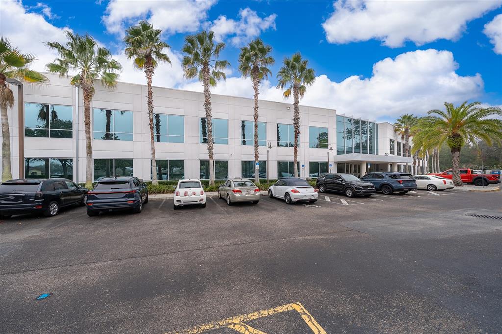 A two-story office building with a parking lot and palm trees in front — 7560 RED BUG LAKE RD UNIT 2014, OVIEDO, FL
