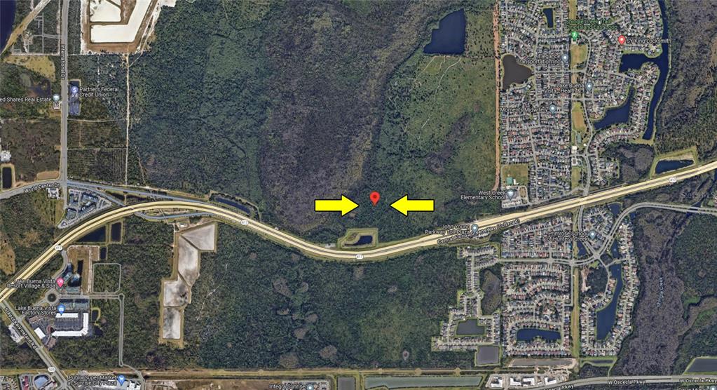 This aerial map shows a wooded plot of land located near a highway and neighborhood — Vacant Land on INTERNATIONAL DRIVE S, ORLANDO, FL