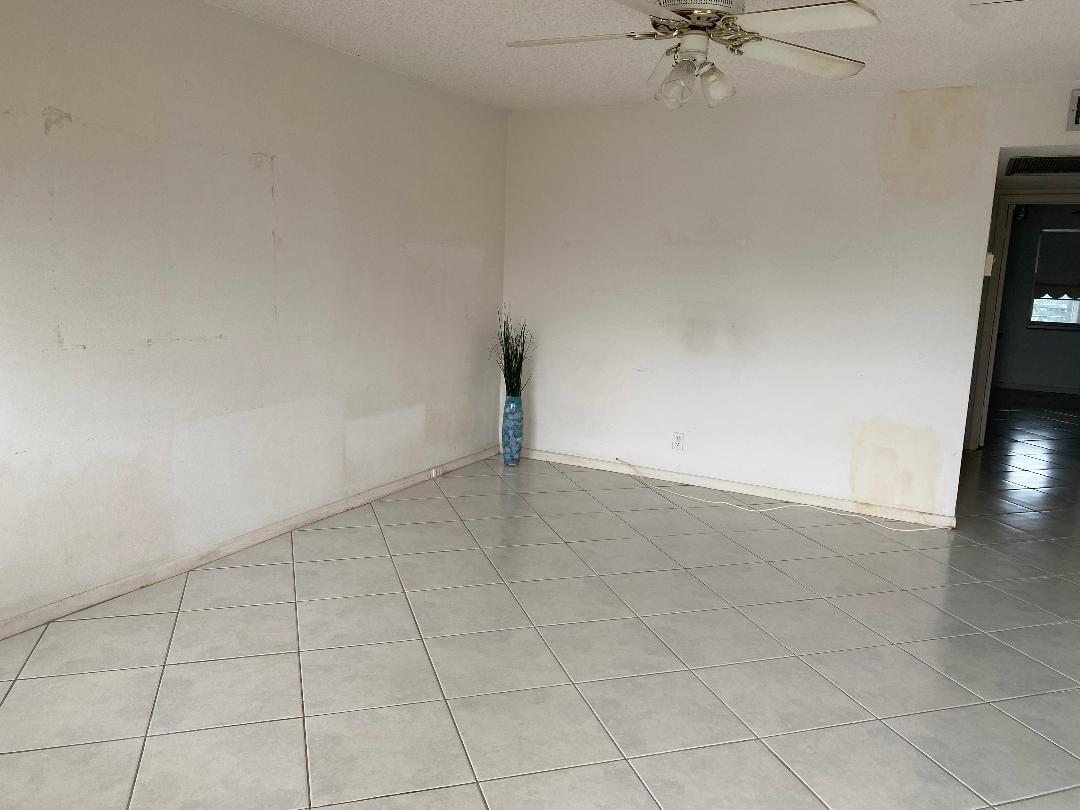 An empty room with light-colored floor tiles, white walls, and a ceiling fan — 4096 Westbury H # 4096, Deerfield Beach FL 33442, DEERFIELD BEACH, FL