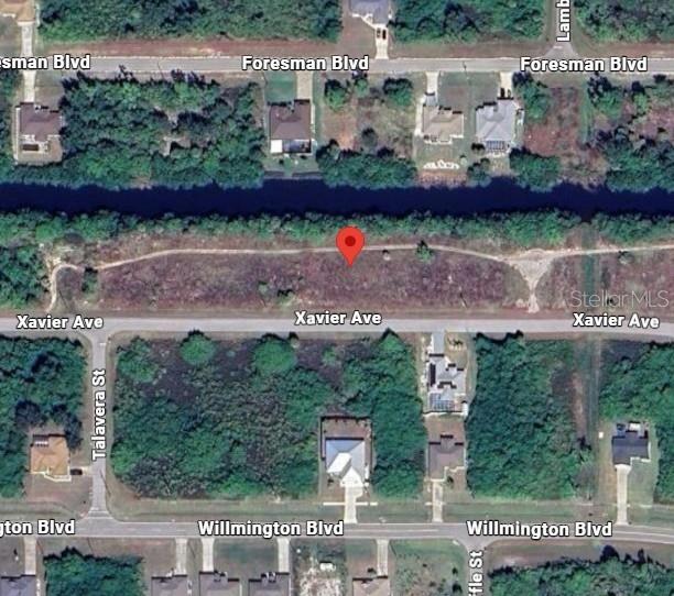 This is an aerial map view of a vacant residential lot marked with a pin — 12960 XAVIER AVENUE, PORT CHARLOTTE, FL