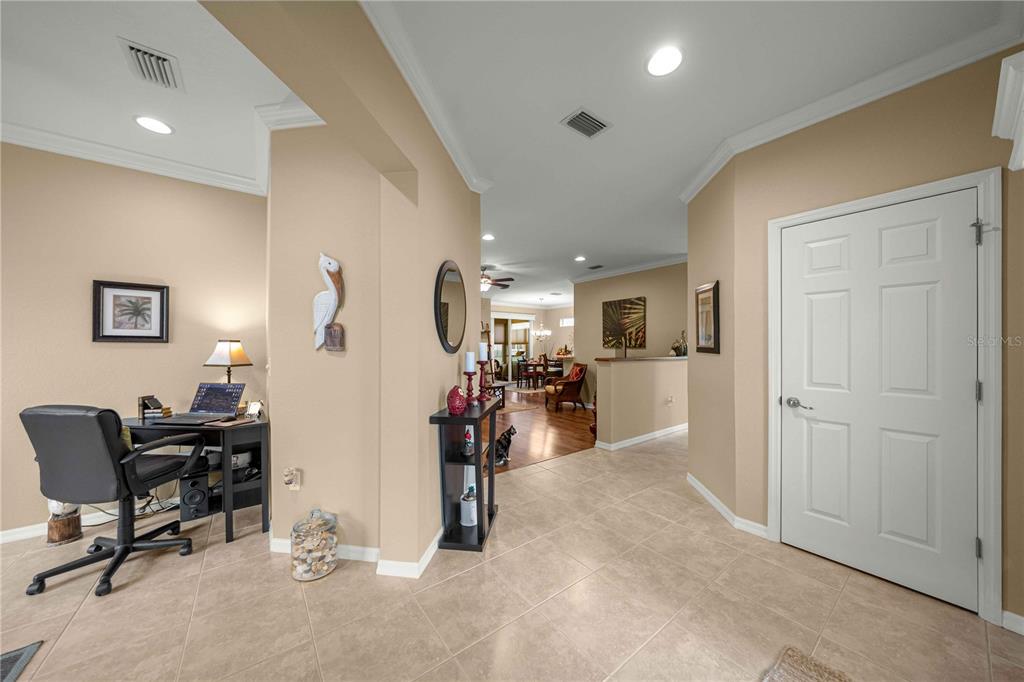 A tiled entryway leads to a home office area and a view into the living space — 12503 SE 94TH COURT, SUMMERFIELD, FL