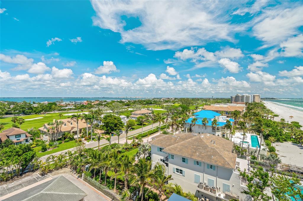 An aerial view of a coastal neighborhood featuring houses, a golf course, and the beach — 1000 LONGBOAT CLUB ROAD, LONGBOAT KEY, FL