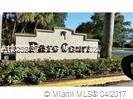 A stone monument sign for Parc Court stands in front of landscaping and palm trees — PLANTATION, FL