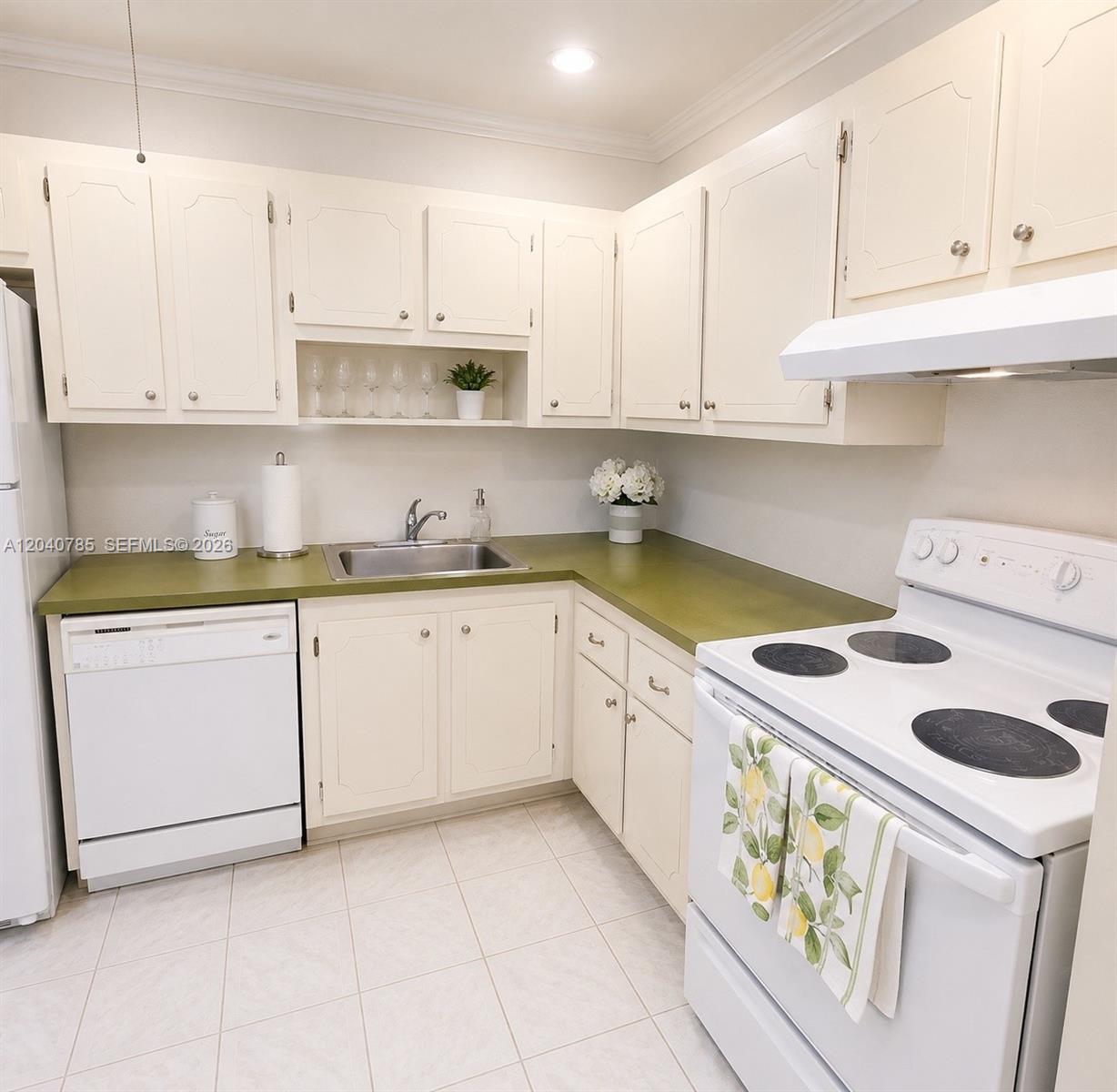 A kitchen features white cabinets, a green countertop, and white appliances — 301 Cambridge Rd # 306, Hollywood FL 33024, HOLLYWOOD, FL