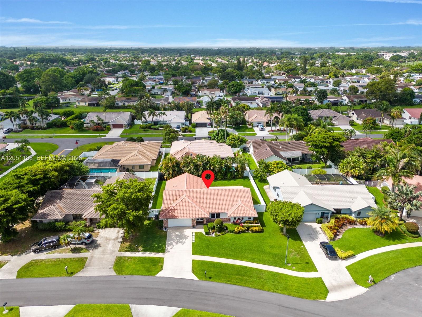 An aerial view shows a suburban house with a red tile roof and a lawn — 22433 Ensenada Way, Boca Raton FL 33433, BOCA RATON, FL