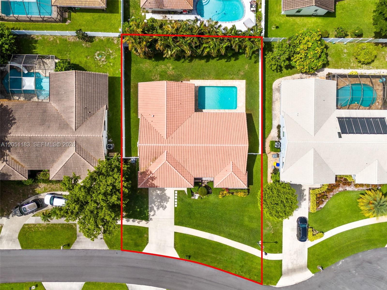An aerial view shows a house with a tiled roof, pool, and fenced backyard — 22433 Ensenada Way, Boca Raton FL 33433, BOCA RATON, FL