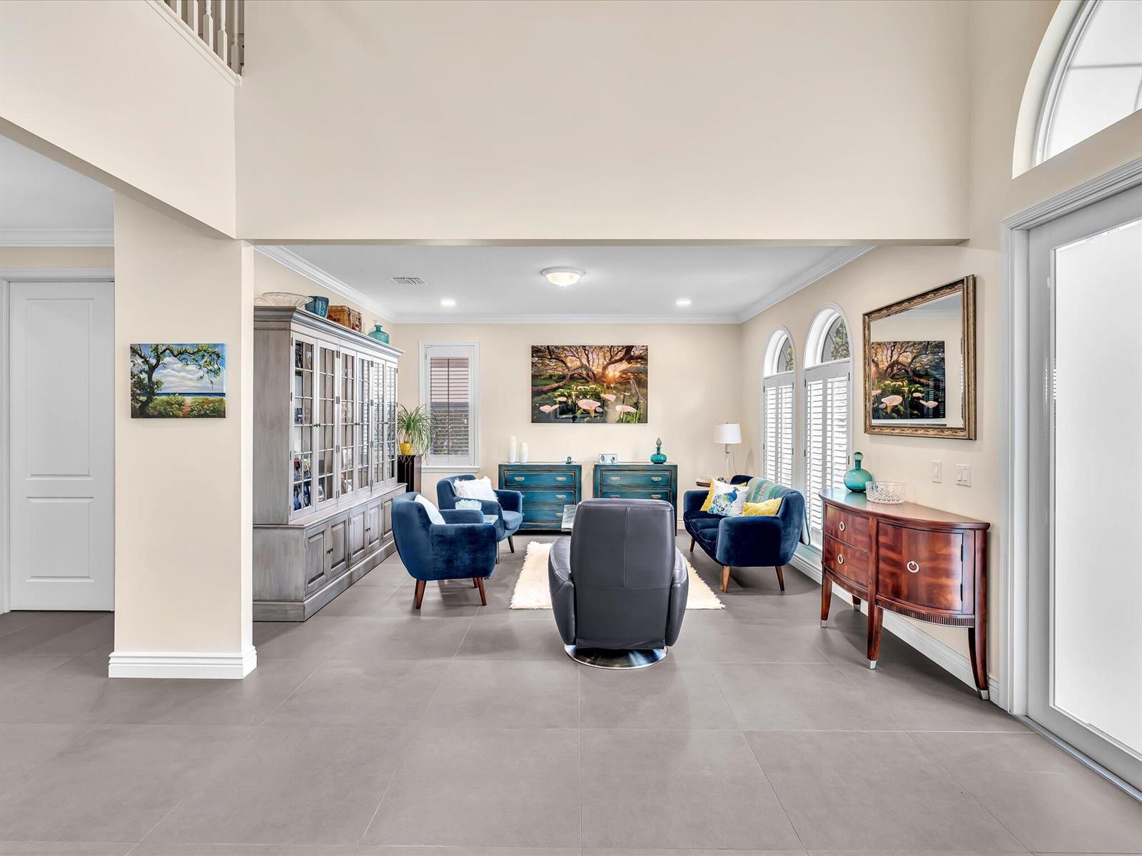 A living room features blue velvet furniture, a grey cabinet, and tile flooring — 4770 Glenn Pine Lane, Boynton Beach FL 33436, BOYNTON BEACH, FL