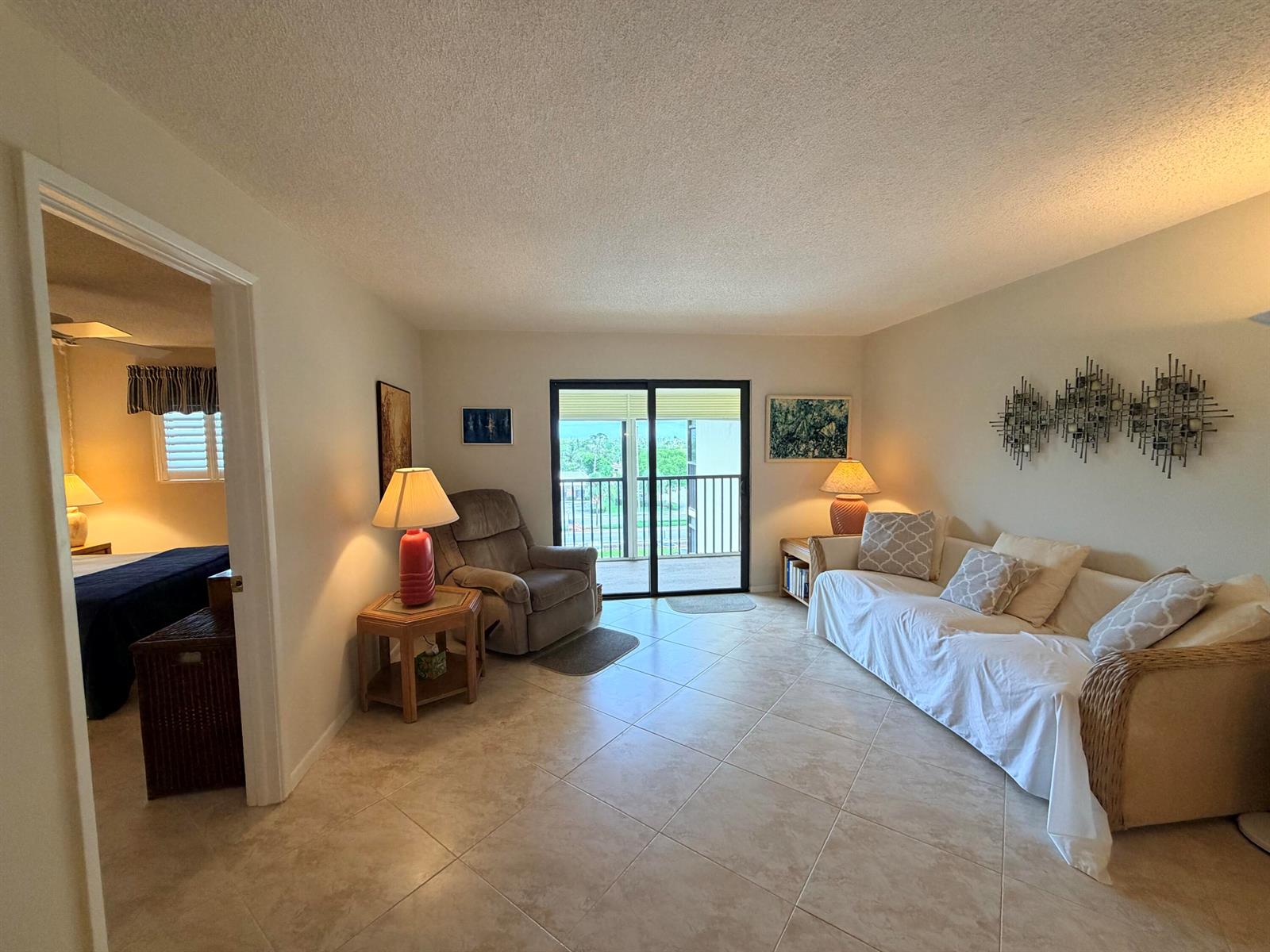 A rectangular swimming pool with a white concrete deck and lounge chairs under a blue sky — 2601 NE 14th Street # 535, Pompano Beach FL 33062, POMPANO BEACH, FL