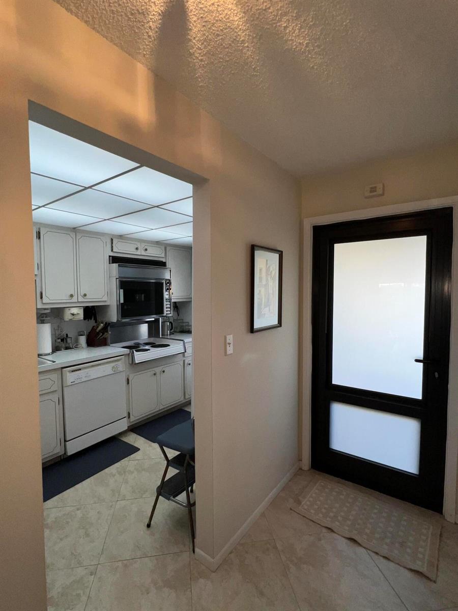 A dining area features a round wooden table, four chairs, and a decorative pendant light — 2601 NE 14th Street # 535, Pompano Beach FL 33062, POMPANO BEACH, FL
