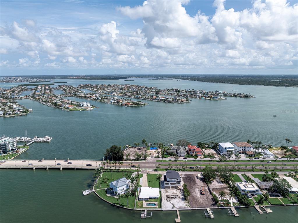 An aerial view shows a bridge connecting waterfront properties and residential islands in a bay — 2 PARADISE LANE, TREASURE ISLAND, FL