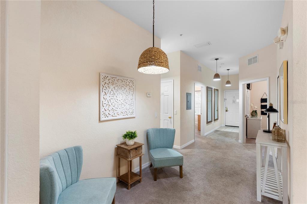 A living room features a gray sofa, a black coffee table, and a sliding glass door — 607 GRAN BAHAMA BOULEVARD UNIT B29/U607, DAVENPORT, FL