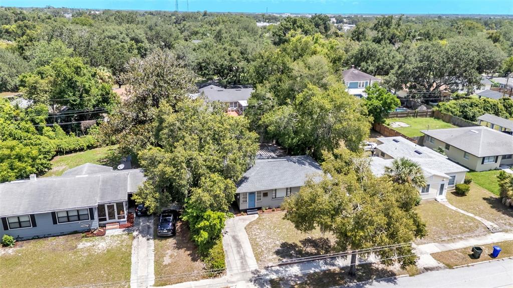 A living room with blue furniture, a coffee table, and an adjacent dining area — 1032 E PALMETTO STREET E, LAKELAND, FL