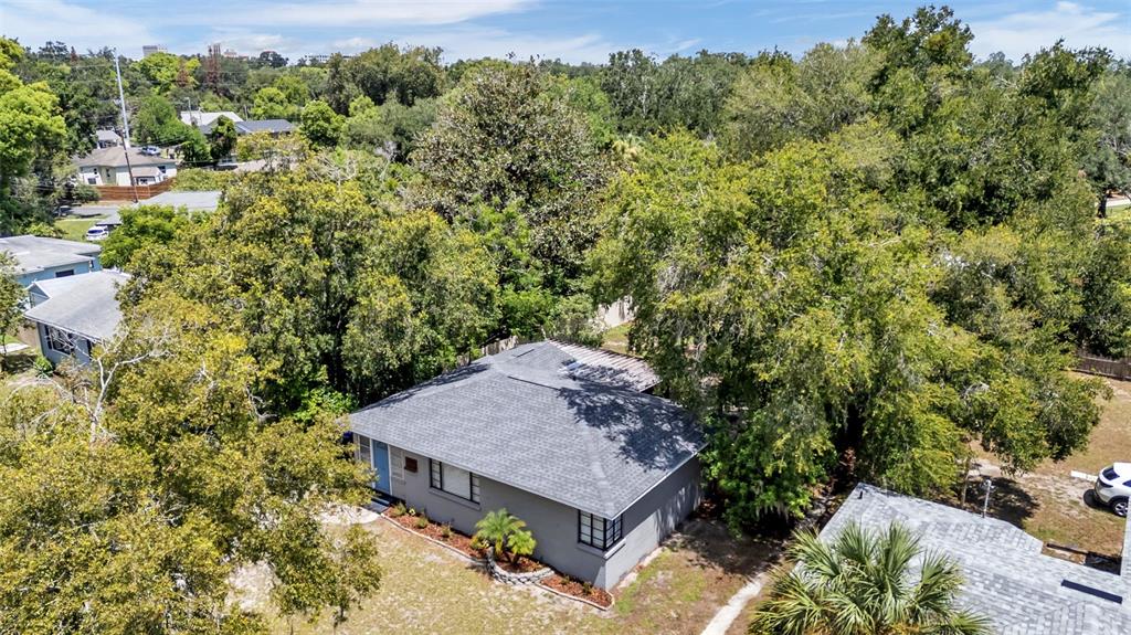 An aerial view shows a residential neighborhood with a red location pin over a house — 1032 E PALMETTO STREET E, LAKELAND, FL