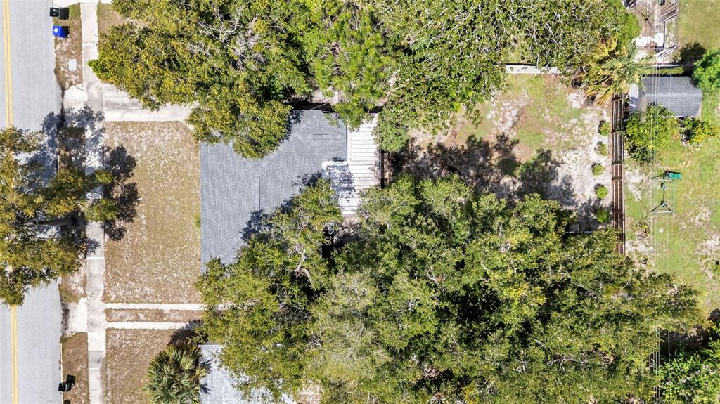 A kitchen features white cabinets, a stainless steel refrigerator, a sink, and a glass-paneled door — 1032 E PALMETTO STREET E, LAKELAND, FL