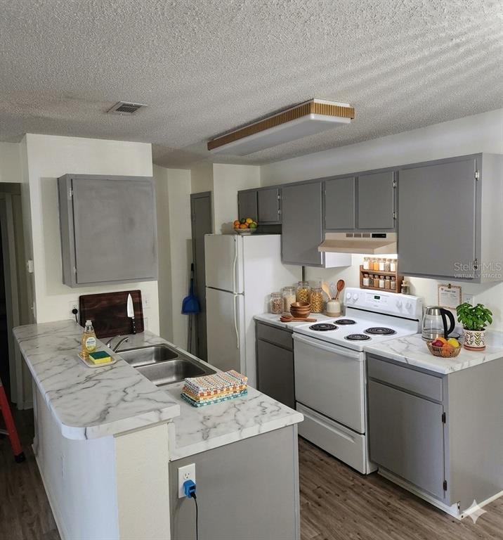 A kitchen with gray cabinets, white marble-patterned countertops, and white appliances — 974 LEEWARD PLACE UNIT 205, ALTAMONTE SPRINGS, FL