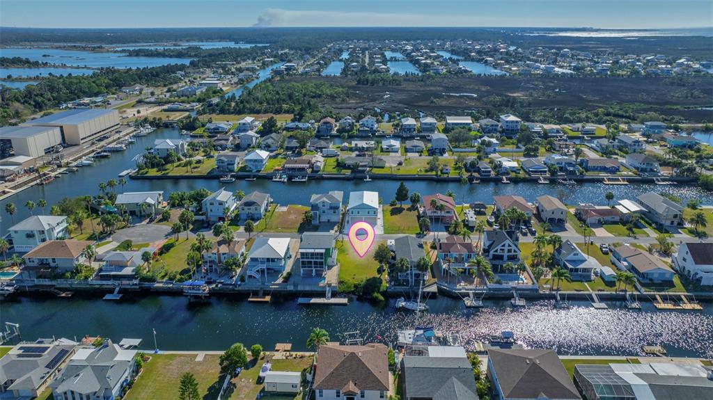 An aerial view shows a waterfront residential neighborhood with a highlighted vacant lot — 4029 CASA COURT, HERNANDO BEACH, FL