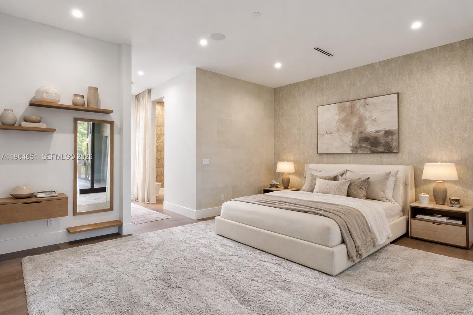 A modern bedroom features a neutral color palette, a textured accent wall, and floating wood shelves — 871 NE 83rd St, Miami FL 33138, MIAMI, FL