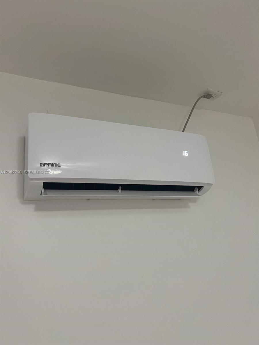 A white wall-mounted mini-split air conditioning unit is installed on a plain white wall — 10822 SW 142nd Ct # 1, Miami FL 33186, MIAMI, FL