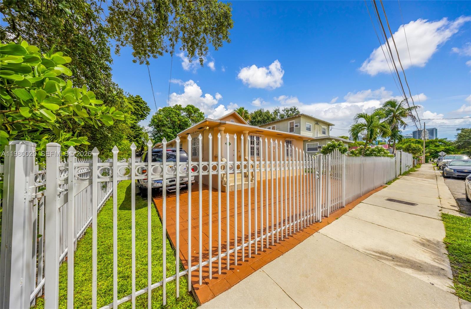 A single-story house with a white metal fence and a paved driveway — 287 NW 31st St, Miami FL 33127, MIAMI, FL