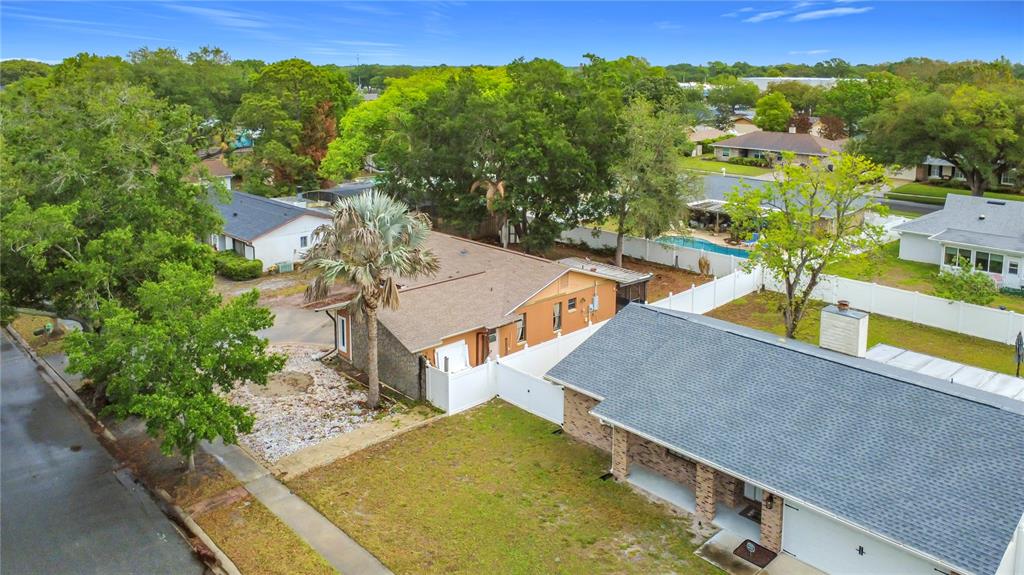 An aerial view shows two suburban houses with shingled roofs, white fences, and mature trees — 5503 ALBERT DRIVE, WINTER PARK, FL