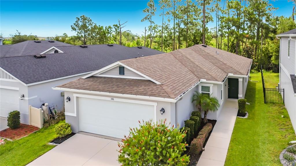 An aerial view of a single-story suburban house with a brown roof and gray siding — 386 PRESERVE POINTE BOULEVARD, DAVENPORT, FL