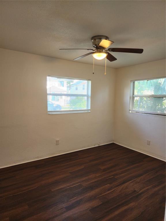 An empty bedroom with white walls, dark wood-look flooring, and a ceiling fan — 2227 HIGHLAND STREET UNIT 2, ST PETERSBURG, FL