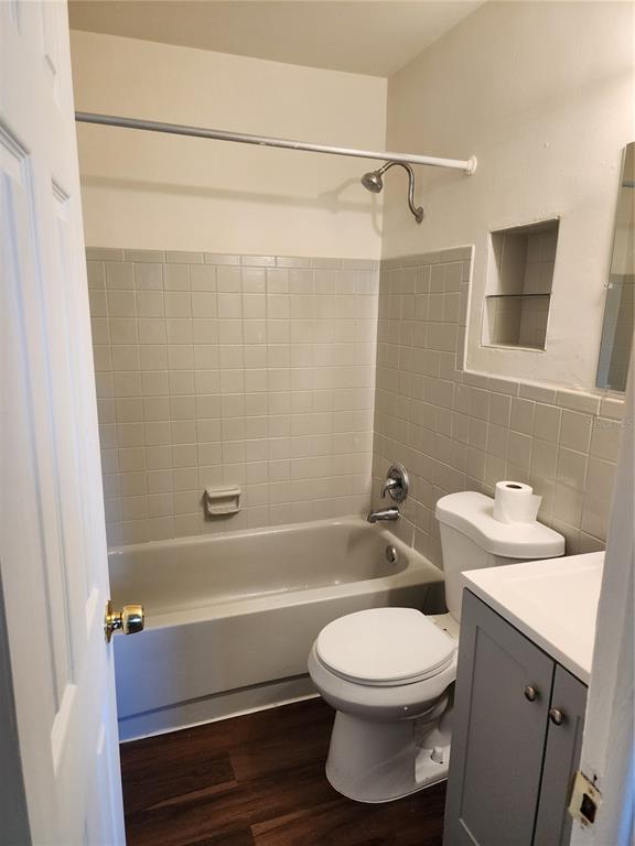 A small bathroom features a tub-shower combination, a white toilet, and a grey vanity cabinet — 2227 HIGHLAND STREET UNIT 2, ST PETERSBURG, FL