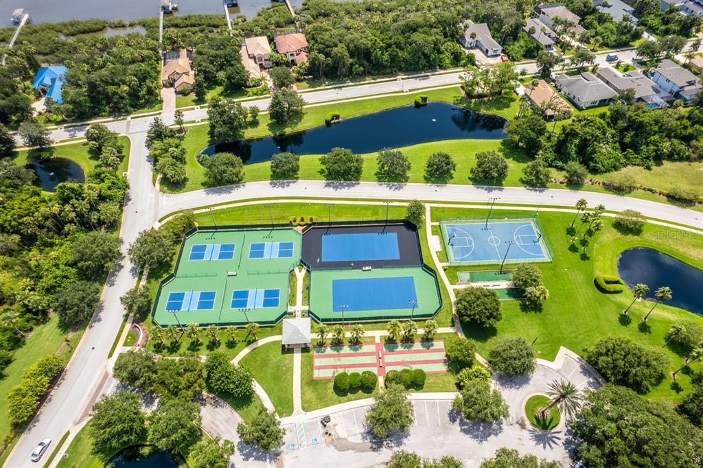 Aerial view of a community recreational area featuring tennis courts, a basketball court, and ponds — 78 N LAKEWALK DRIVE, PALM COAST, FL