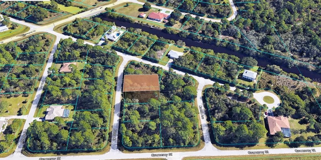 This aerial view shows a vacant, wooded residential lot highlighted in a suburban neighborhood — 15297 CASTO AVENUE, PORT CHARLOTTE, FL