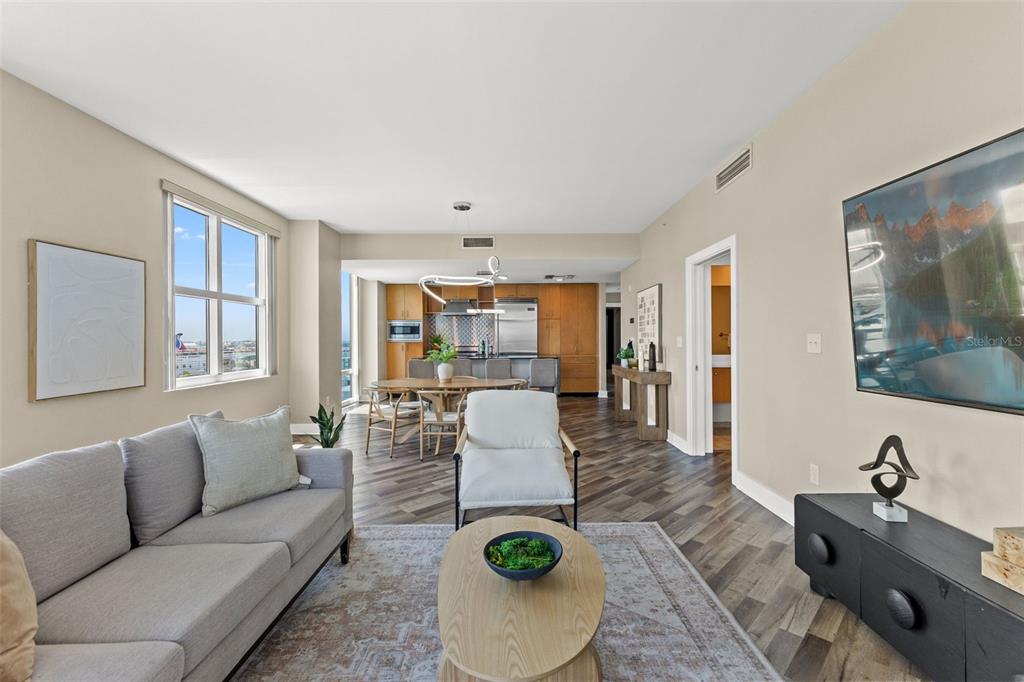 A living room features a sofa, two armchairs, a coffee table, and a wall-mounted television — 1120 E KENNEDY BOULEVARD UNIT 1229, TAMPA, FL